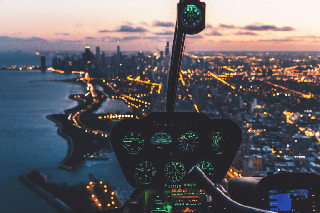 Evening helicopter cockpit view overlooking Houston skyline with city lights