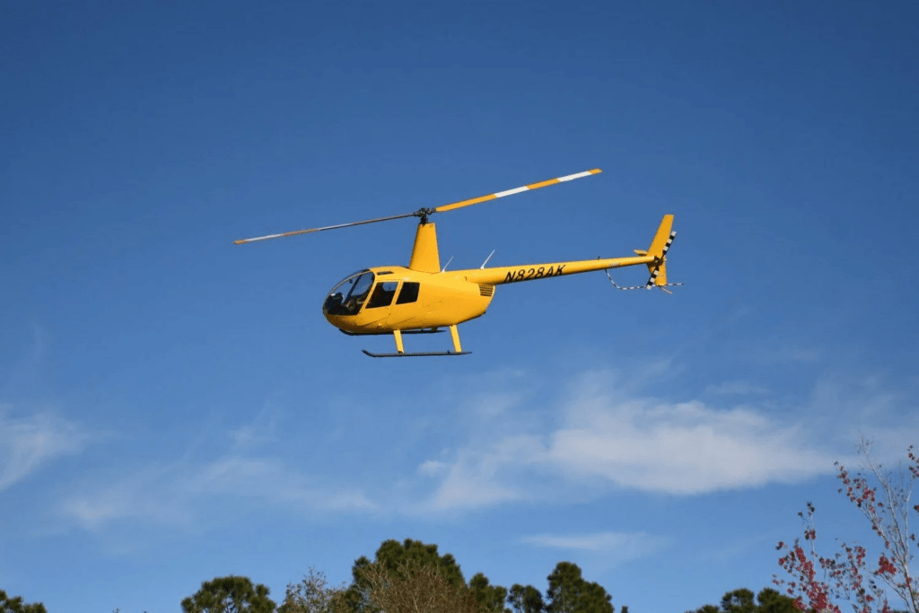 Yellow helicopter in clear sky used for efficient business travel in Houston