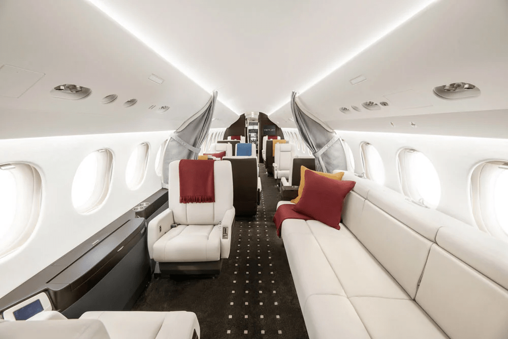 Luxury interior of a Falcon 7X private jet designed for long-haul comfort and privacy