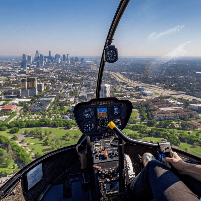 Helicopter cockpit view over Houston skyline showcasing elevated city ride experience