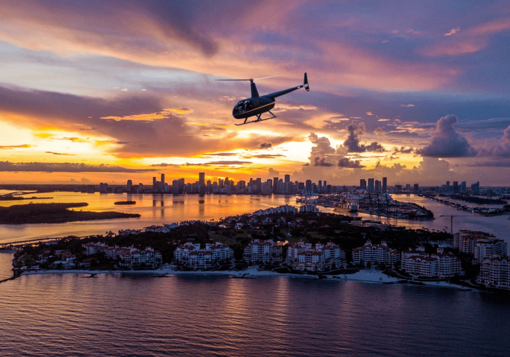 Helicopter at sunset over city waterfront illustrating scenic rides versus charter services