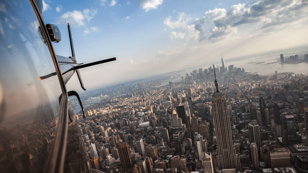 Helicopter window view over city skyline illustrating comparison between scenic tours and charter flights